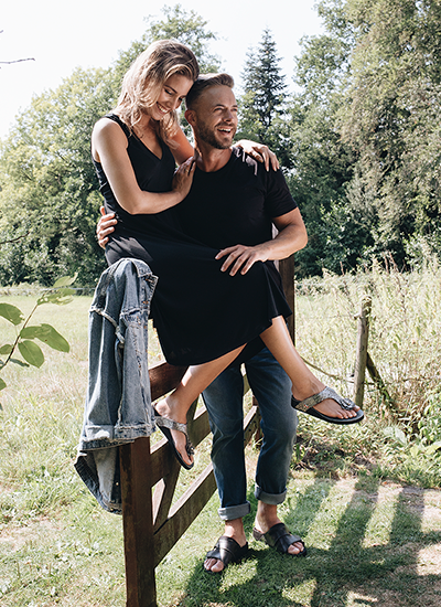 Legs standing on a step wearing black and grey custom sandals